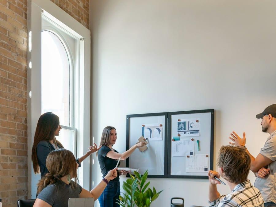 A small team working together around a table in an open-plan office