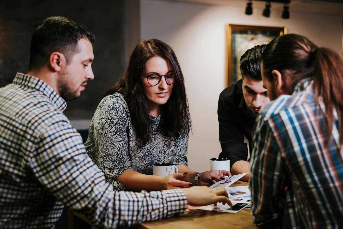 A team reviewing business documents together around a table